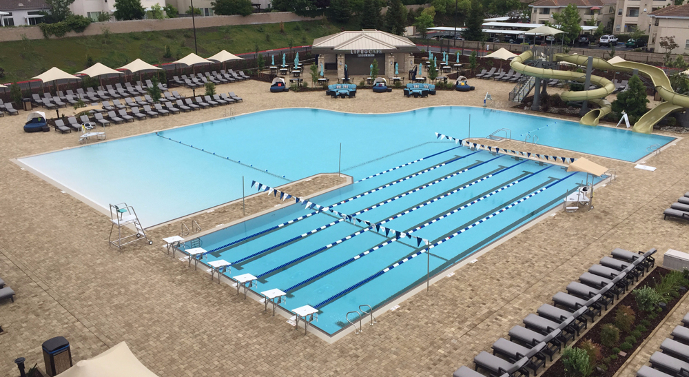 Outdoor lap/leisure pool with a waterslide at Life Time Athletic in Roseville, California